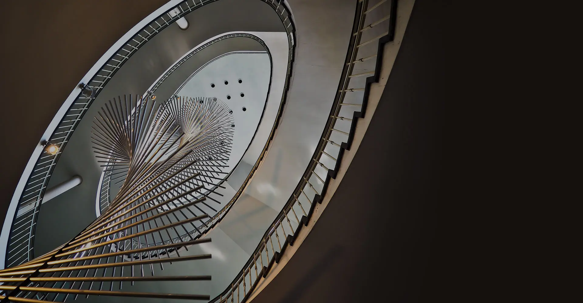 Overhead view of a spiral staircase with a circular skylight