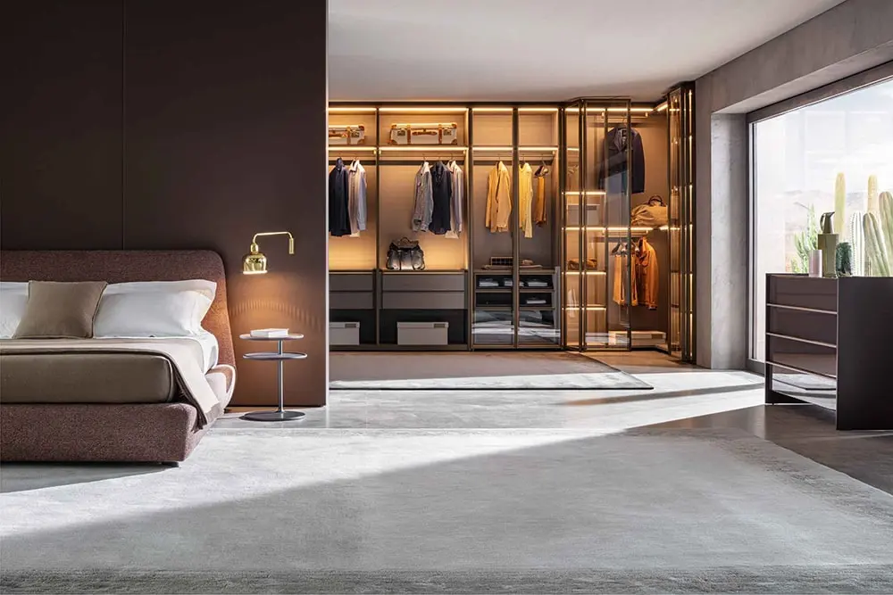 an elegant bedroom with molteni contemporary wardrobe design with glass foldable doors and lighting below shelves