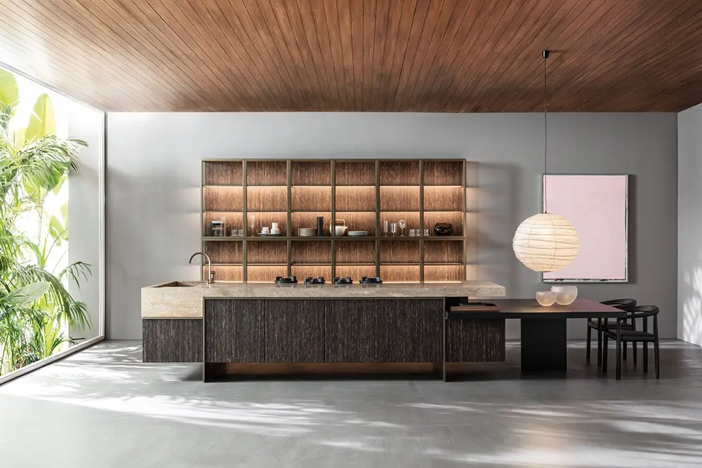 vvd dada kitchen with an island with a thick marble top and wooden doors in front of a suspended modern sideboard with glass doors