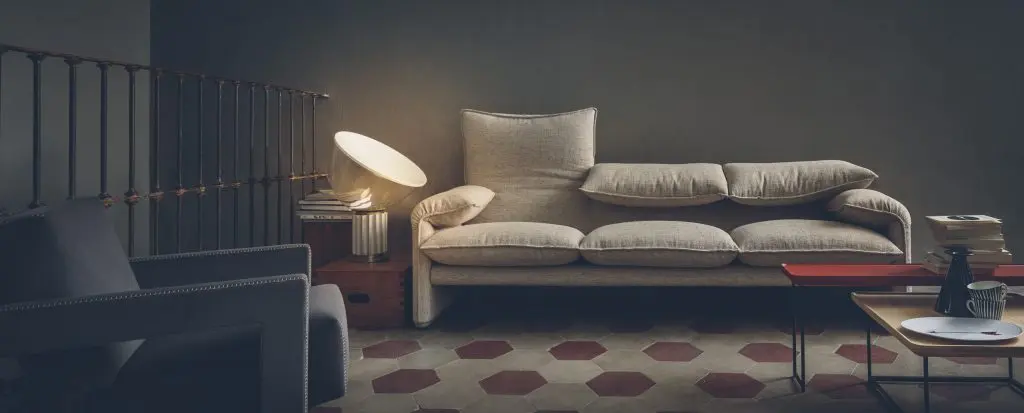 Cassina Maralunga sofa in beige with adjustable headrests in a dim living room