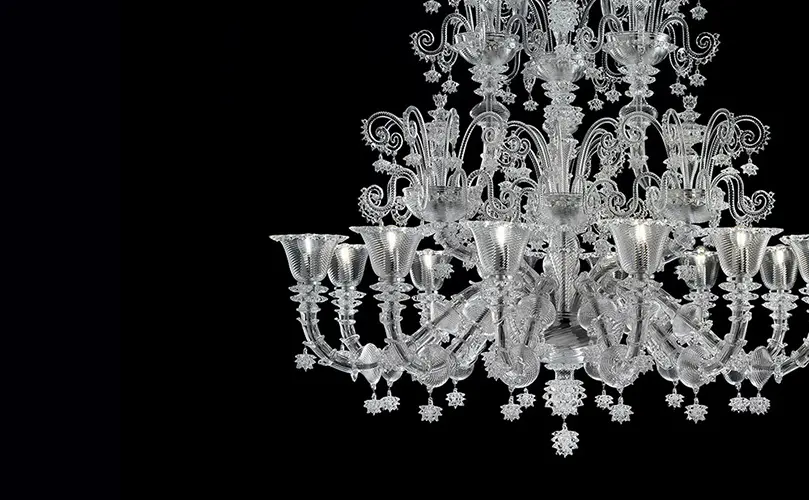 crystal glass chandelier with multiple candle-style arms on a black background