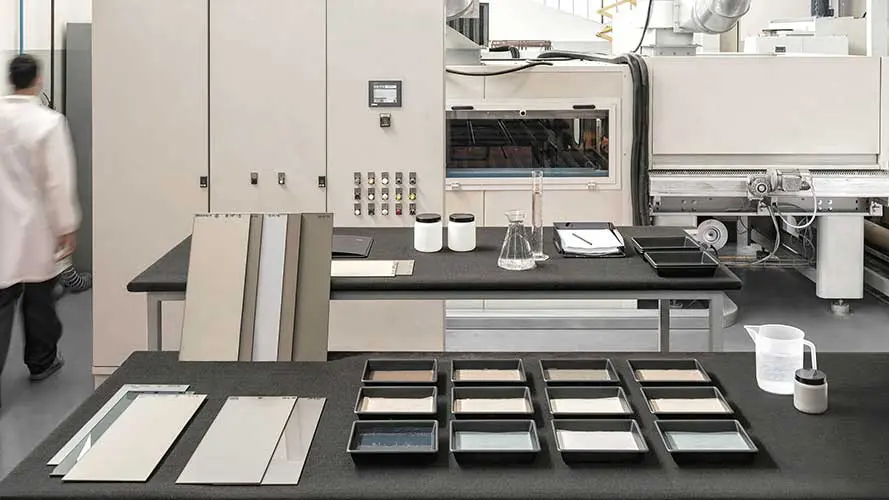 Material testing lab with fabric swatches and finish trays on dark counters