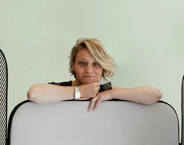 Rachele Pellegatta, head architect and designer at Esperiri, leaning on a chair