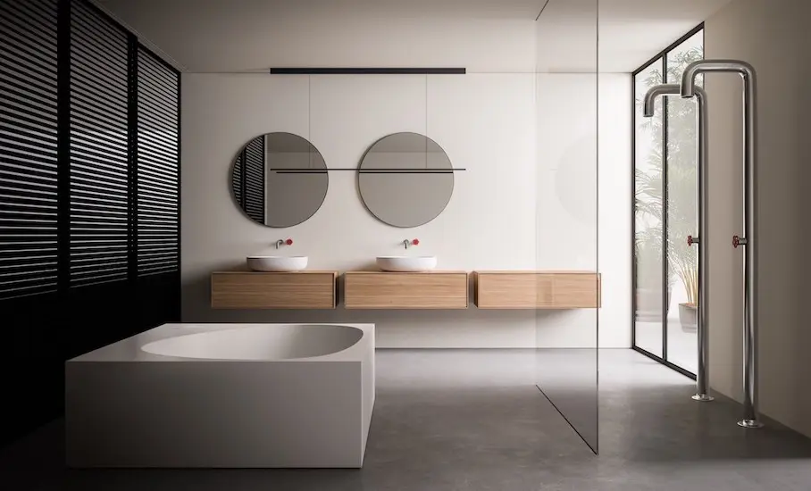 Minimalist bathroom with a freestanding white tub, floating double vanity, round mirrors and a glass shower screen