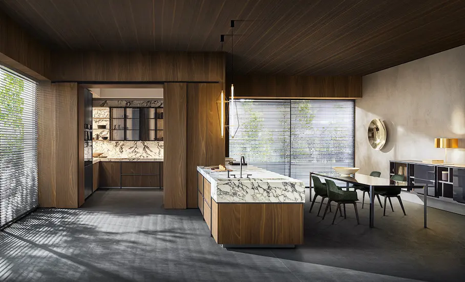 Open kitchen with dark wood cabinetry, a marble-clad island and an adjoining dining area with green chairs