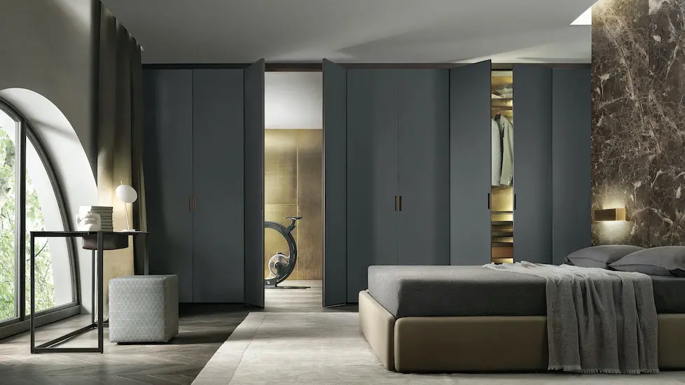 Bedroom with a dark grey wardrobe wall, a brown marble accent wall and low upholstered bed