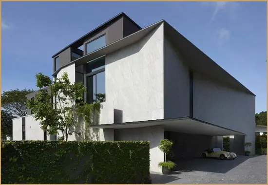 Modern white house with a carport and vintage convertible car