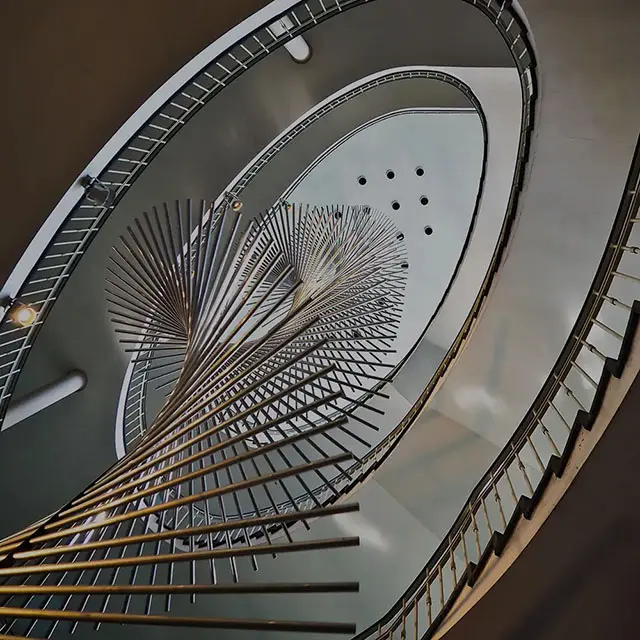 Overhead view of a spiral staircase with a circular skylight