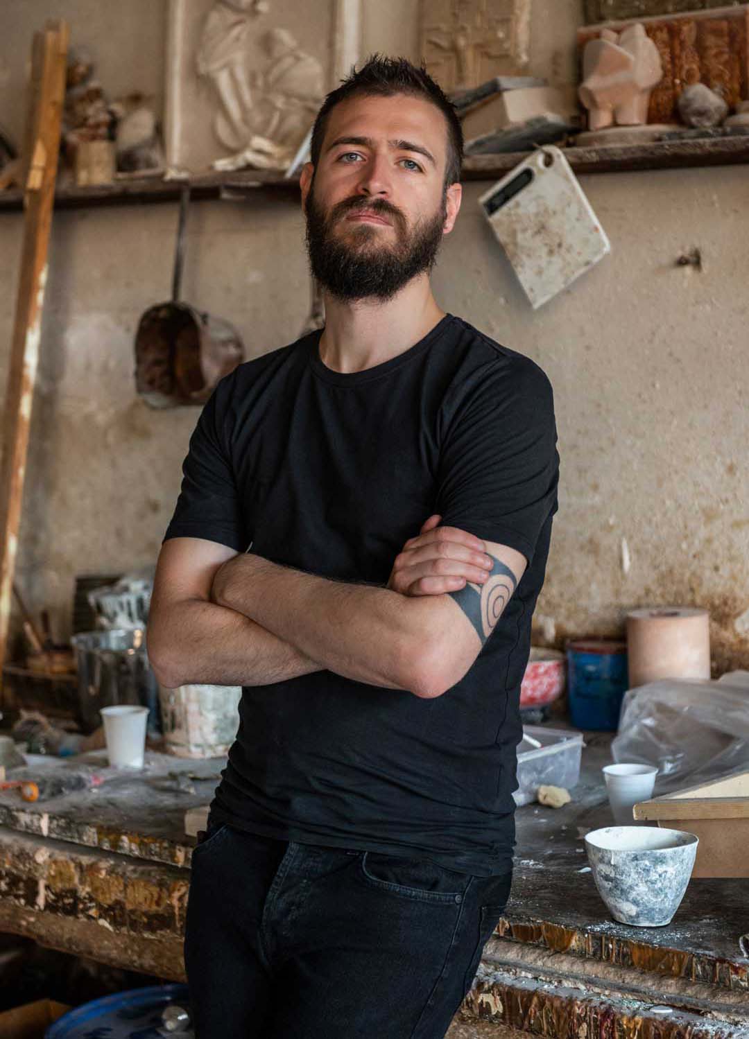 portrait of the designer federico villa dressed in a black tshirt and standing in a studio