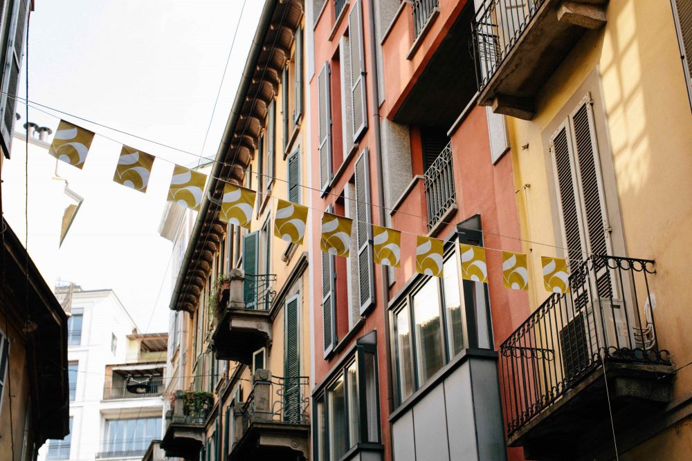 Italian street and Italian buildings with Flags across the street