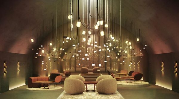 underground vault of central station in milan with lights hanging from the ceiling and designer armchairs