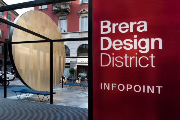 red sign with white text declaring brera design district in milan