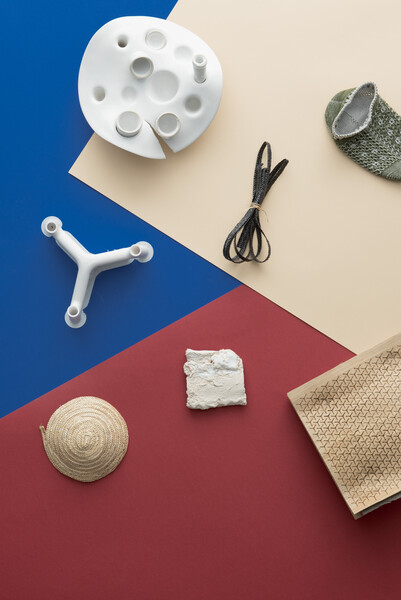 a variety of objects on top of red, blue, and beige colored papers