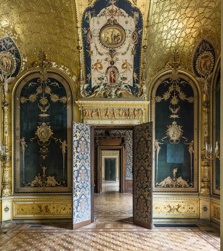 interior image of doorways in a palace decorated with floral patterns and gold ceilings and wooden parquet floors