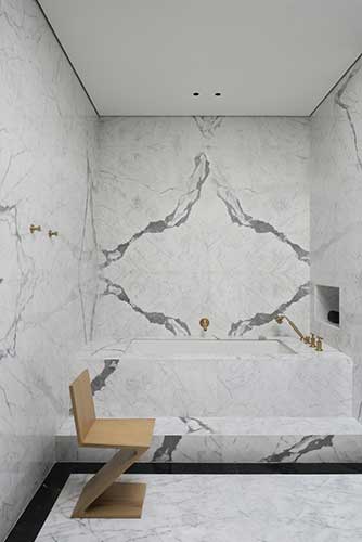 cassina zig zag chair in a modern bathroom covered with Italian marble designed by one of the best interior designer in Dubai