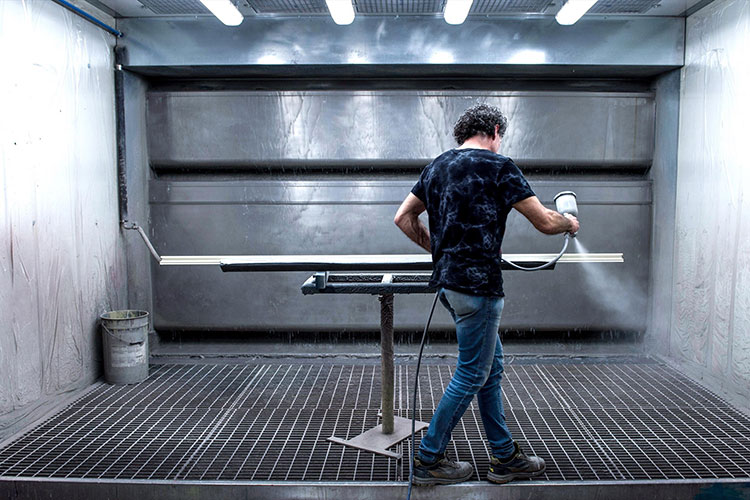 an Italian worker painting wood for an online Italian interior design project