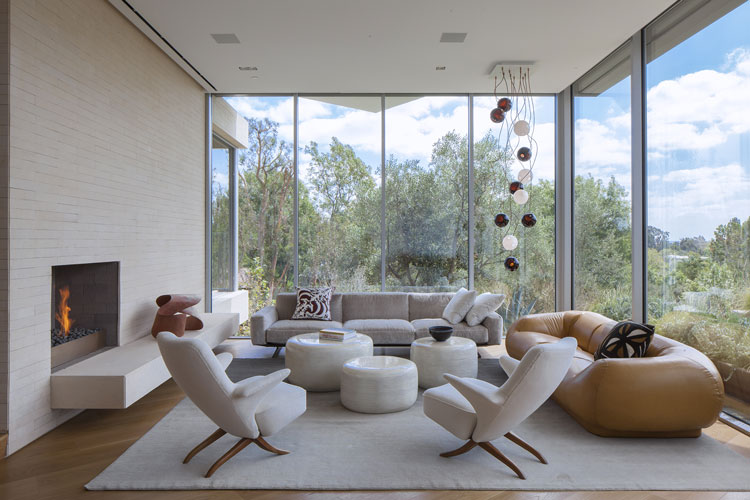 modern living room with large glass windows designed by a high end interior designer in los angeles