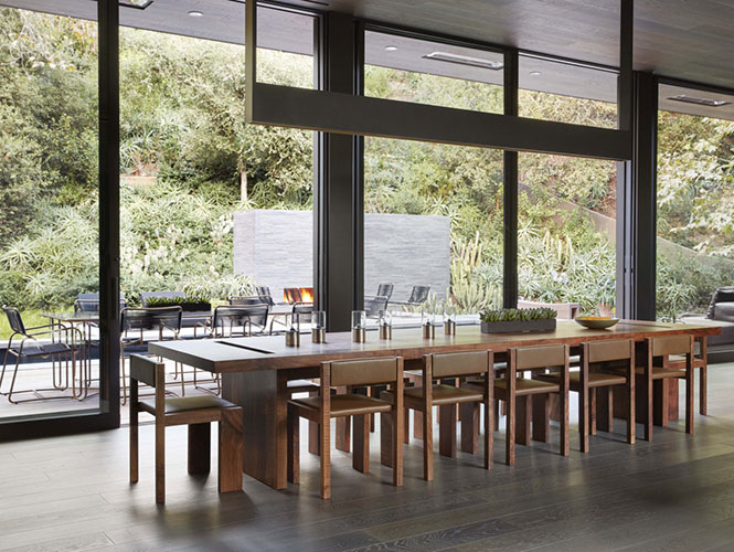 wooden dining table in a contemporary living room designed by one of the top interior design firms in los angeles