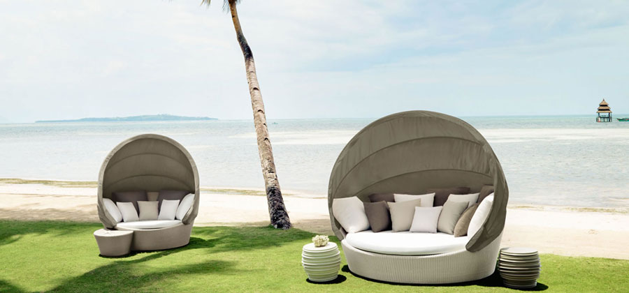 orbit by dedon, one of the best outdoor furniture brands, an outdoor lounge sofa with cover for the sun on the beach