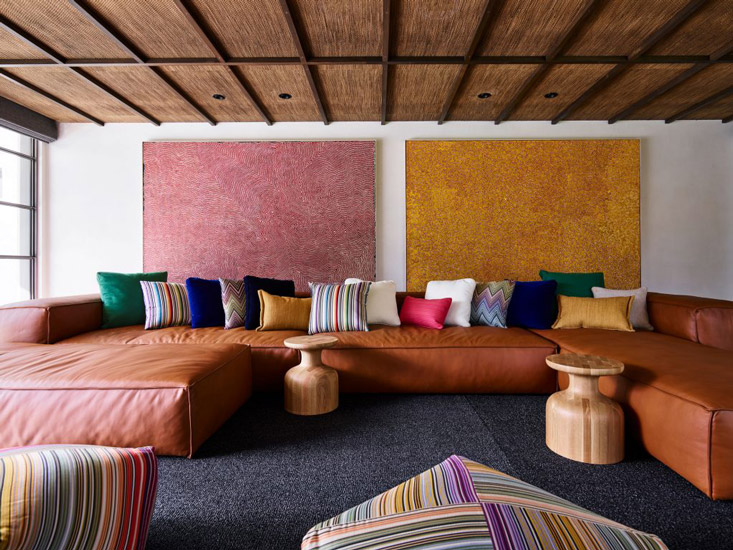 Australian Artworks, custom-made leather sofa and Italian Missoni cushions and footstools for this fusion style Lounge Area designed by Decus Interiors, one of the best interior designers Sydney has to offer