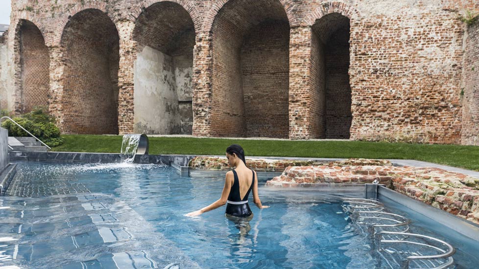 Outdoor pools surronded by the 16th-century walls of the city. QC Terme is The Best Milan Luxury Spa destination for an exclusive retreat after a Furniture shopping tour in Milan's Design City