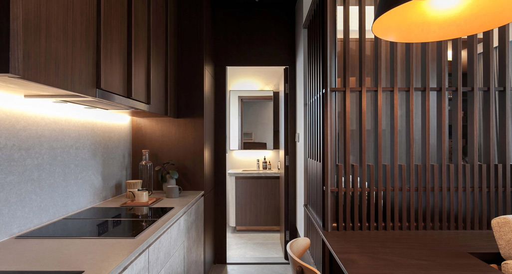 This residence characterized by dark walnut wood and light grey marble, is a project designed by Studio Adjective, one of the best interior design Hong Kong has to offer
