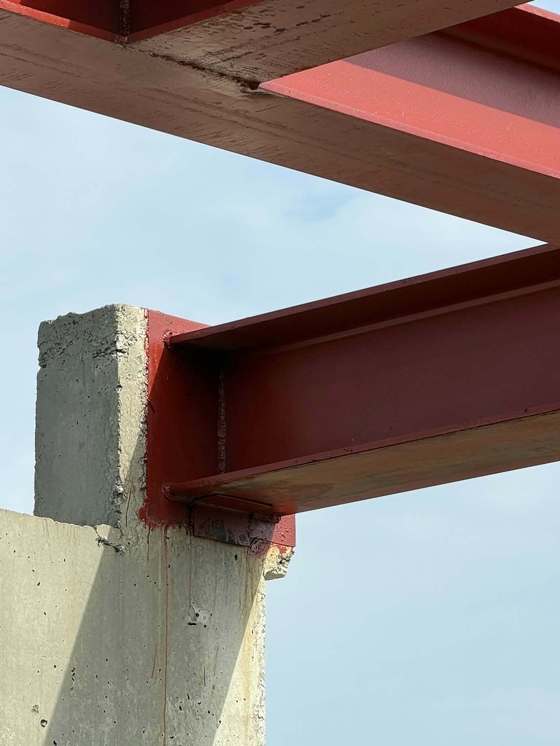 Detail of a red metal beam for the villa interior design in Lagos